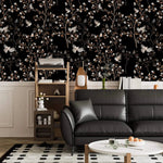 Vintage bird haven wallpaper with birds and blossoms on black above wainscoting in a living room with black sofa