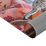 Rolled corner of the Vintage Bohemian Woven Rug, peach-pink floral cushion and cat paw partially visible, terracotta woven face at top