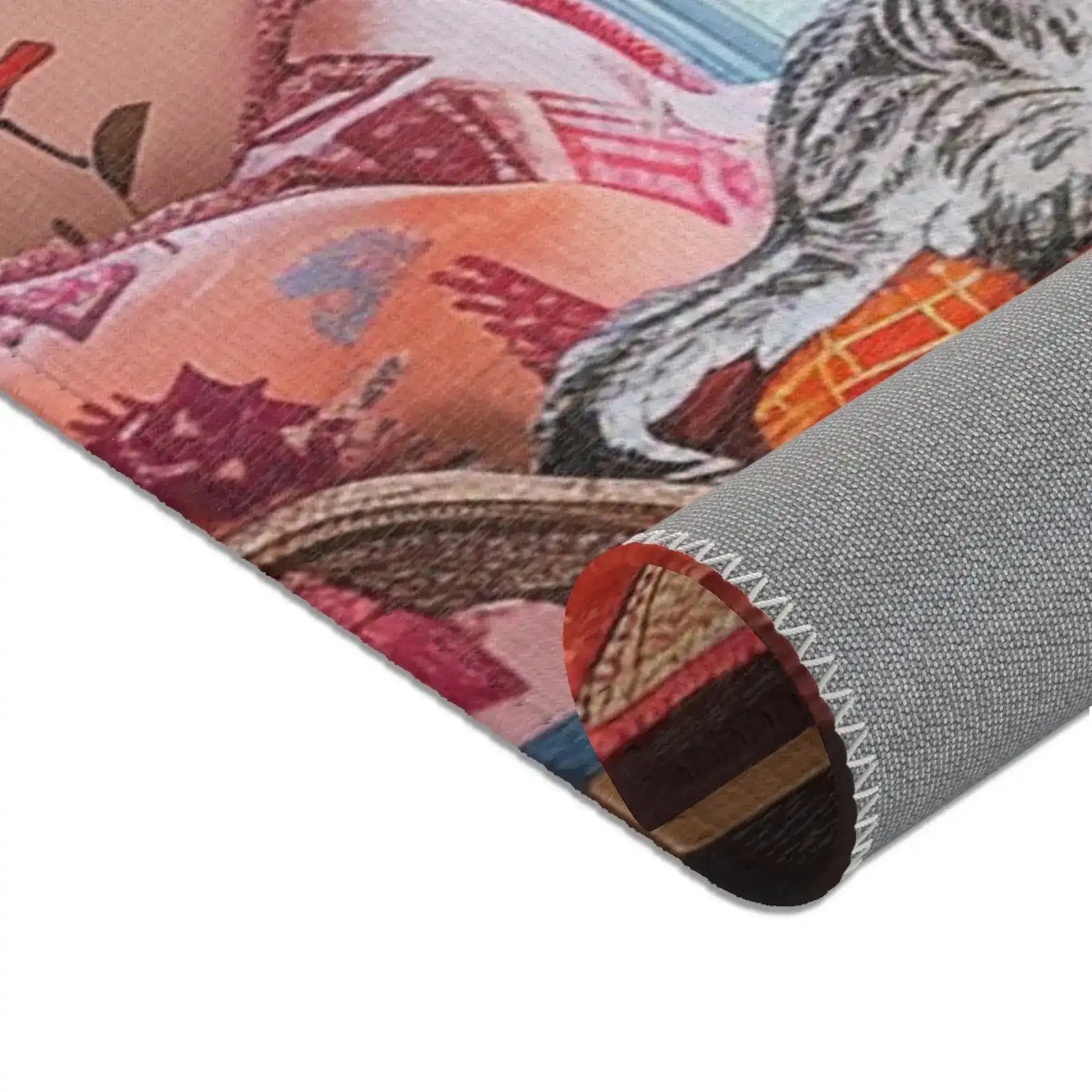 Rolled corner of the Vintage Bohemian Woven Rug, peach-pink floral cushion and cat paw partially visible, terracotta woven face at top