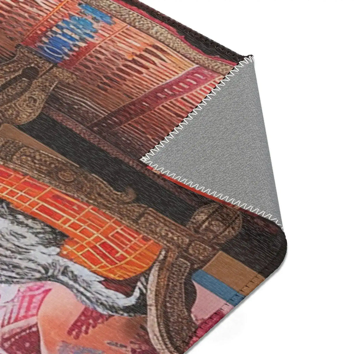 Rolled edge of the Vintage Bohemian Woven Rug showing underside backing, rust-red and navy blue woven stripe pattern on face