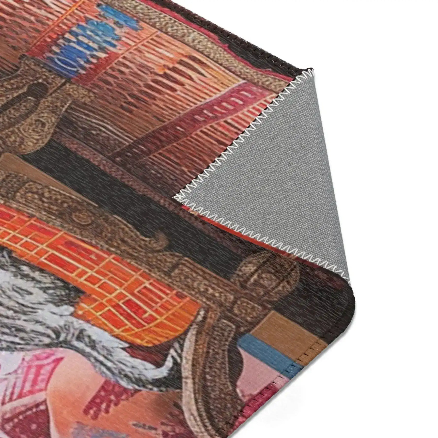 Rolled edge of the Vintage Bohemian Woven Rug showing underside backing, rust-red and navy blue woven stripe pattern on face