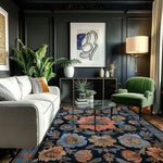 A beautifully styled living room featuring a Vintage Bouquet Hand Tufted Area Rug with a floral design. The wool rug adds elegance to the space, making it perfect for both the living room and formal dining room settings. This vintage rug, with its Persian rug influences, complements the modern decor, including a white sofa, green armchair, and abstract wall art.