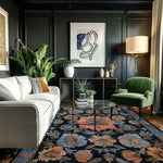 A beautifully styled living room featuring a Vintage Bouquet Hand Tufted Area Rug with a floral design. The wool rug adds elegance to the space, making it perfect for both the living room and formal dining room settings. This vintage rug, with its Persian rug influences, complements the modern decor, including a white sofa, green armchair, and abstract wall art.