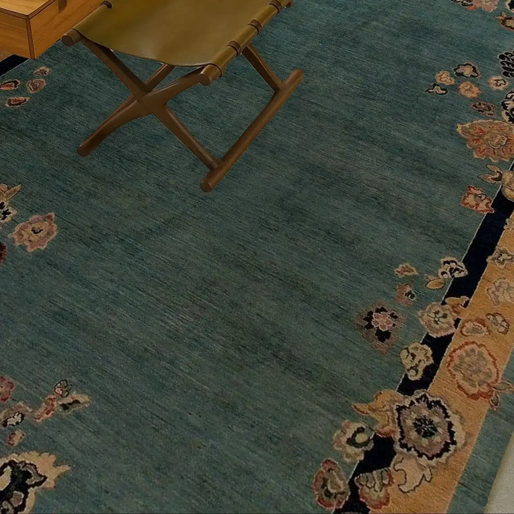 Close-up of a vintage floral bordered Chinoiserie blue wool hand-knotted area rug, perfect for large living rooms. The rug features intricate floral patterns on a rich blue background, showcasing its elegance as a living room area rug.