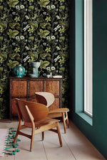 Vintage Floral Elegance moody wallpaper of leaves and daisies next to a teal wall and antique cabinet
