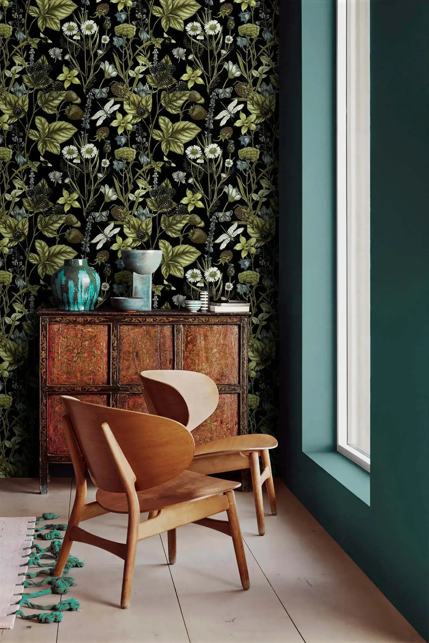 Vintage Floral Elegance moody wallpaper of leaves and daisies next to a teal wall and antique cabinet