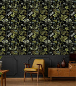 Vintage Floral Elegance wallpaper of foliage and daisies above charcoal panelling with a mustard armchair