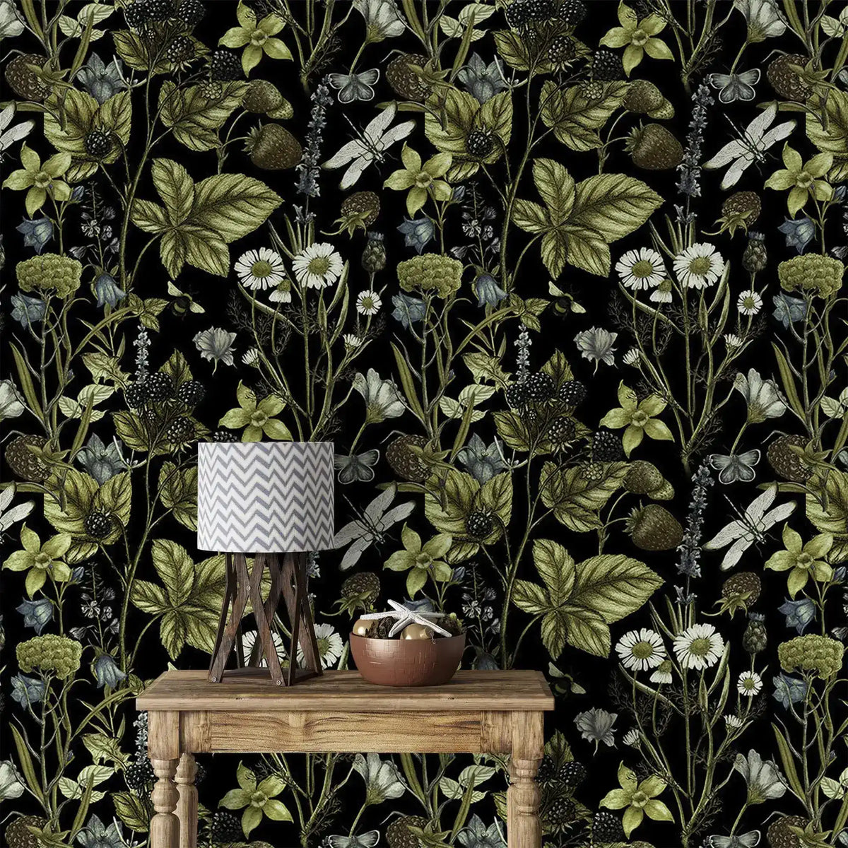 Close view of Vintage Floral Elegance wallpaper, green vines and daisies, behind a rustic console and lamp