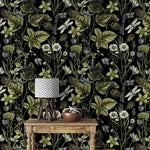 Close view of Vintage Floral Elegance wallpaper, green vines and daisies, behind a rustic console and lamp