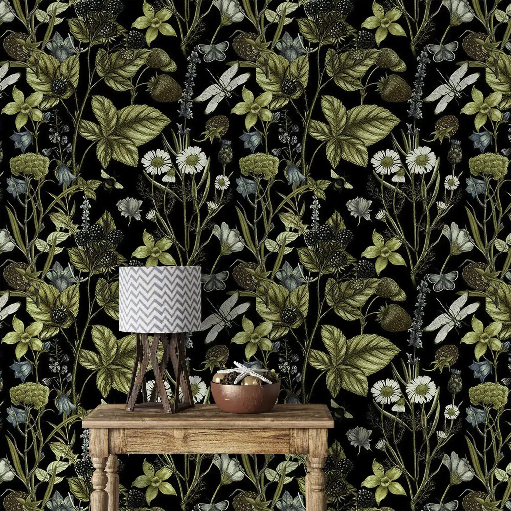 Close view of Vintage Floral Elegance wallpaper, green vines and daisies, behind a rustic console and lamp
