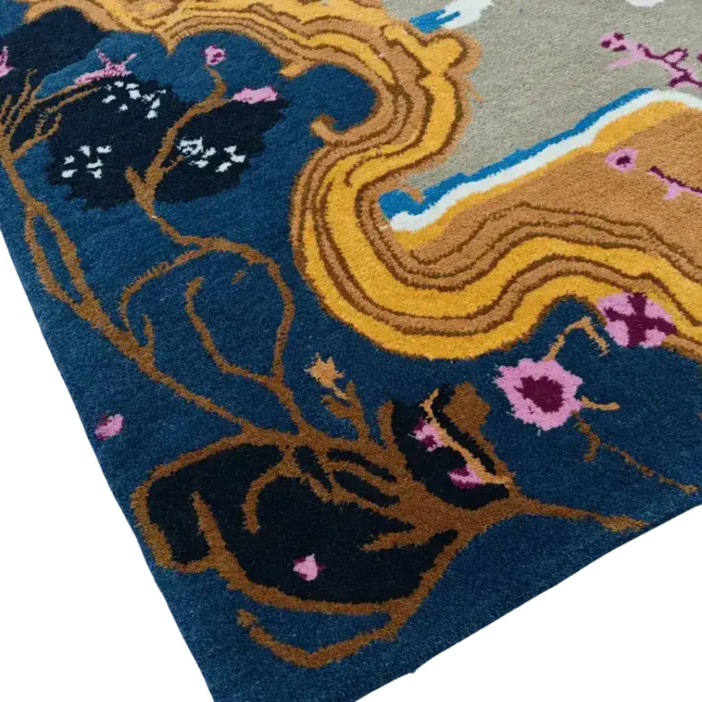 Close-up of a vintage area rug featuring intricate floral patterns with vibrant blue, yellow, and pink hues. This hand-tufted wool rug adds a touch of elegance to any dining room setting, perfect as a dining table rug or a large area rug. Ideal for those seeking dining room carpets with a classic, vintage flair.