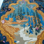 A stunning vintage frame hand tufted area rug, perfect for a dining room, showcasing an intricate forest landscape with vibrant blues, earthy browns, and gold accents. This wool rug offers a luxurious and classic touch, ideal for large area spaces and as a dining table rug.