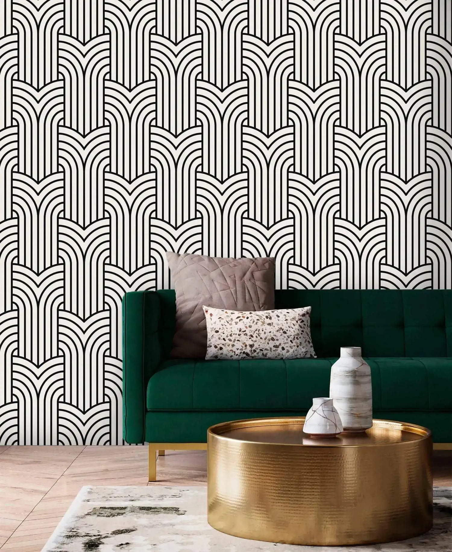 Vintage ornate outline wallpaper, black art deco arches on cream behind an emerald velvet sofa
