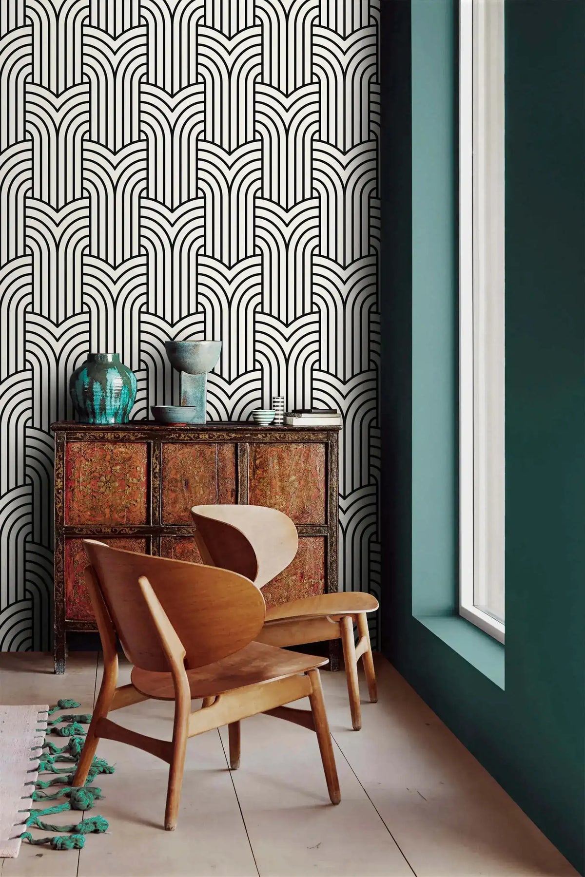 Vintage ornate outline wallpaper by a window with carved cabinet, black art deco arches on cream