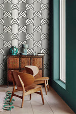 Vintage ornate outline wallpaper by a window with carved cabinet, black art deco arches on cream