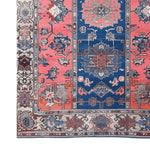A vibrant Vintage Radiance Hand Knotted Area Rug showcasing a classic Persian design with intricate patterns in shades of blue and pink. Perfect for adding a touch of elegance to living rooms, this 8x10 vintage rug brings timeless style to your home decor.