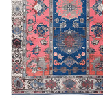 A vibrant Vintage Radiance Hand Knotted Area Rug showcasing a classic Persian design with intricate patterns in shades of blue and pink. Perfect for adding a touch of elegance to living rooms, this 8x10 vintage rug brings timeless style to your home decor.