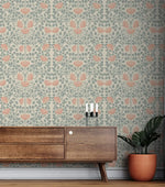 Vintage rose garden wallpaper above walnut sideboard, coral roses and sage vines on a cream ground