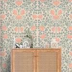 Vintage rose garden wallpaper, coral roses on sage trellis vines over cream, above a cane cabinet