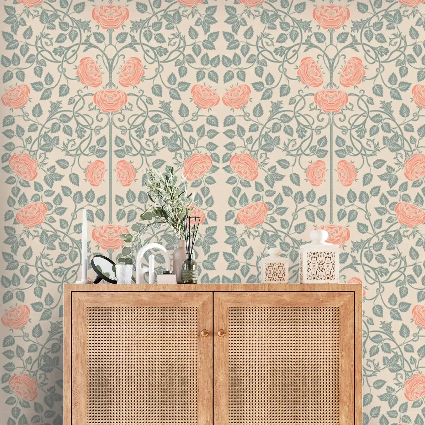 Vintage rose garden wallpaper, coral roses on sage trellis vines over cream, above a cane cabinet