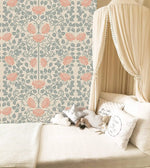 Vintage rose garden wallpaper in a nursery, coral roses on sage trellis vines beside a canopy bed