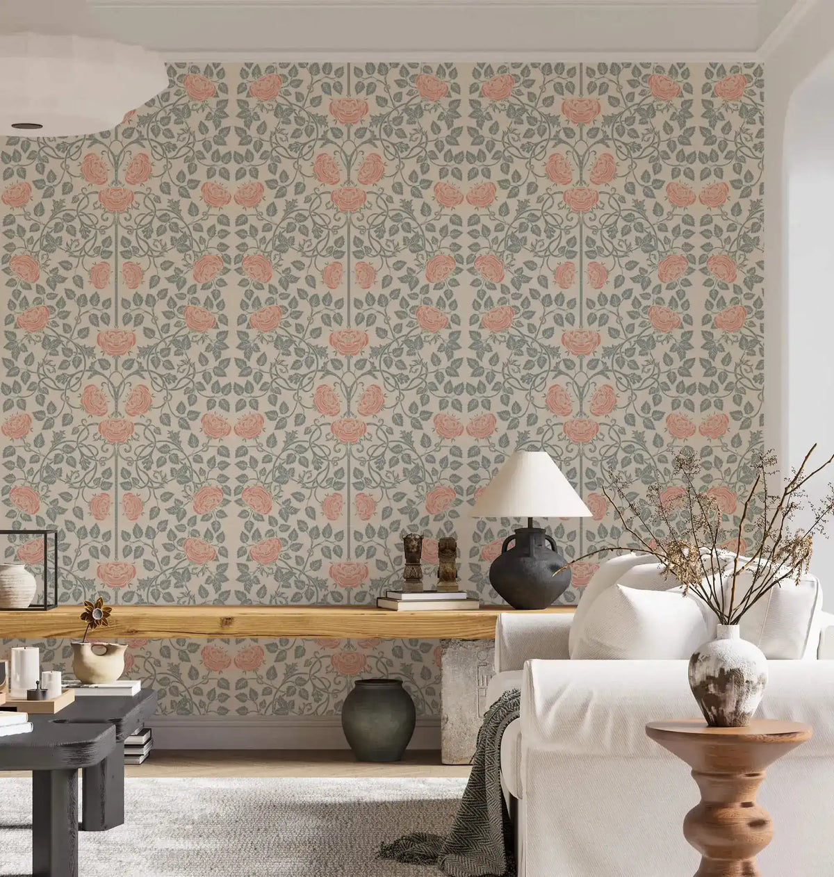 Vintage rose garden wallpaper in airy living room, coral roses on sage trellis behind a white sofa
