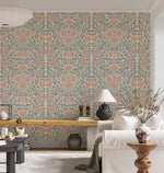 Vintage rose garden wallpaper in airy living room, coral roses on sage trellis behind a white sofa