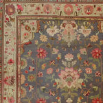 Close-up view of a Vintage Rose Vine Hand Knotted Area Rug, showcasing intricate floral patterns with vibrant colors on a soft background. Perfect for adding elegance to living room spaces, this 8x10 Persian-style rug features detailed floral motifs that enhance its vintage charm.