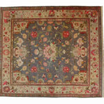 Top view of a Vintage Rose Vine Hand Knotted Area Rug featuring intricate floral patterns in shades of pink, green, and cream on a muted gray background. This elegant Persian-style rug is perfect for adding a touch of classic charm to living rooms, especially in sizes like 8x10, making it an ideal choice for those seeking a vintage floral rug design.