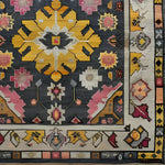 A vibrant vintage tribal hand-knotted area rug showcasing a bold geometric and floral design. The rug features a striking combination of yellow, pink, and grey hues, perfect for adding a touch of Persian elegance to any living room. Ideal for those seeking large living room rugs with a vintage flair.