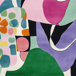 A vibrant and colorful area rug featuring abstract patterns in a mix of pink, purple, green, and orange hues. This hand-tufted wool rug showcases a contemporary design, perfect as a square area rug for living room spaces, adding a modern touch to any decor.