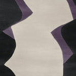Close-up view of the Vivid Flow Pattern Hand Tufted Rug, showcasing its contemporary abstract design with bold black and purple curves against a neutral background, perfect for enhancing living room spaces with a modern wool rug aesthetic.