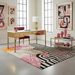 Modern office with a desk, chair, abstract art, and decorative items.