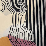 Close-up view of a contemporary area rug featuring bold, abstract black and white stripes with organic line patterns, perfect for adding a modern touch to any living room or bedroom. This hand-tufted wool rug incorporates subtle hues of pink and mustard, making it an eye-catching addition to your home decor.