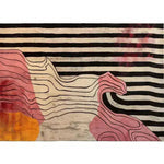 A vibrant hand-tufted area rug featuring bold black and white stripes with abstract pink and orange shapes. Perfect for adding a contemporary touch to living rooms or bedrooms, this wool rug offers an artistic flair to any space.