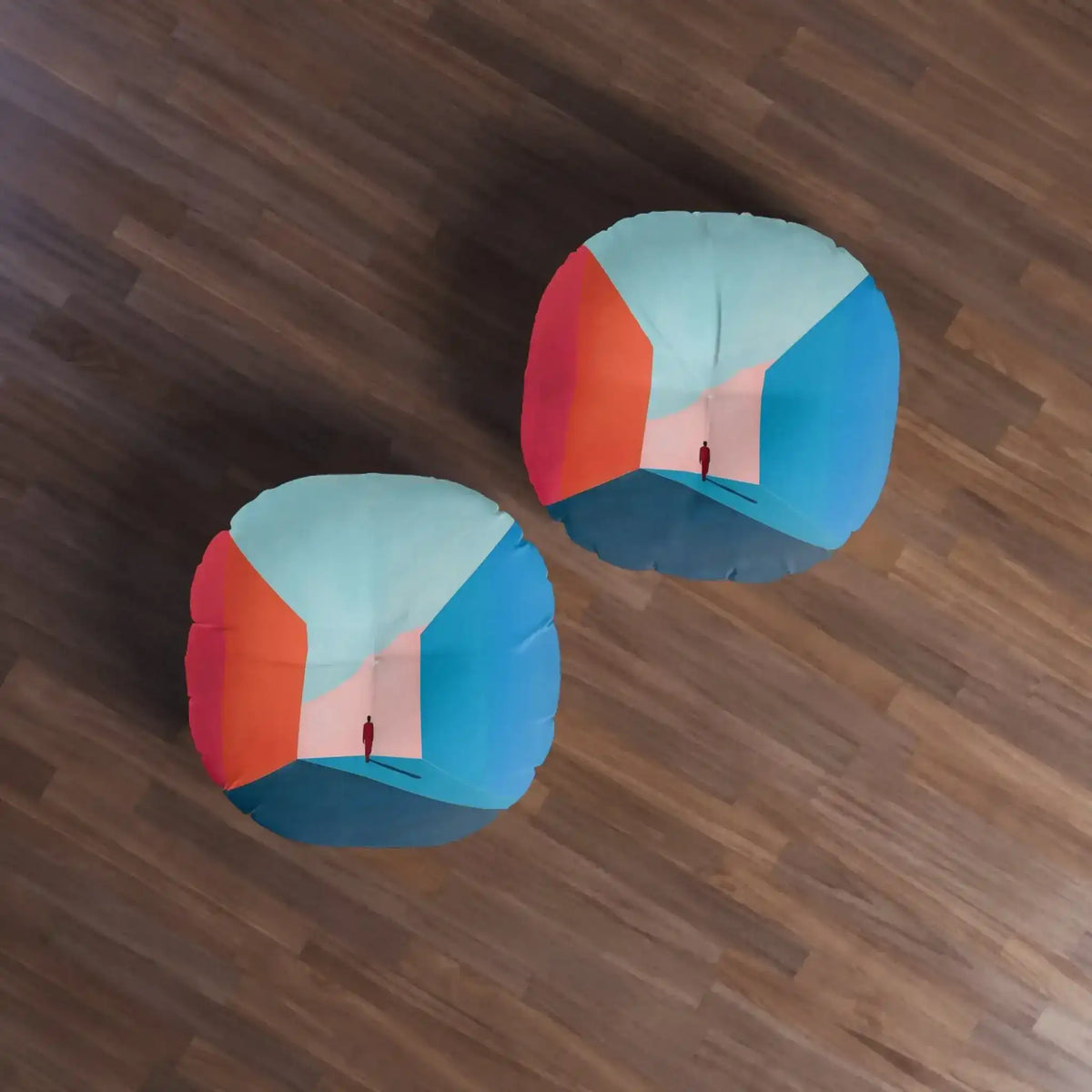 Void Walk Floor Pillow styled in room on gray rug next to wooden shelf with plant, minimalist blue-red corridor art visible