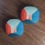 Single Void Walk Floor Pillow in-room from above on gray rug beside wooden shelf and plant, blue-red geometric art design
