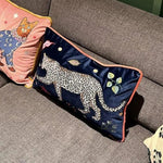 Decorative throw pillow featuring a walking leopard design on a blue background, perfect for adding a jungle accent to your home decor.