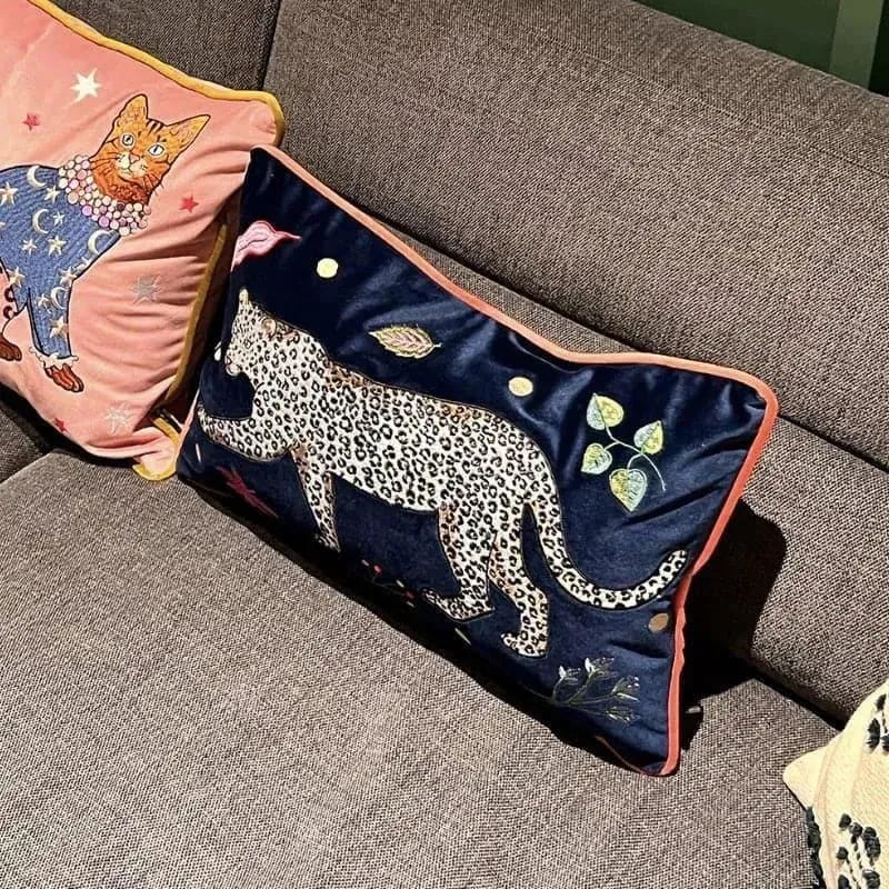 Decorative throw pillow featuring a walking leopard design on a blue background, perfect for adding a jungle accent to your home decor.