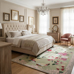 Neatly arranged bedroom with a large bed, floral rug, and decorative elements.