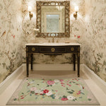 Bathroom with ornate mirror, sink, a floral wool rug, and floral wallpaper