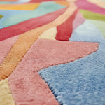 Close-up of a colorful geometric-patterned rug with vibrant colors.