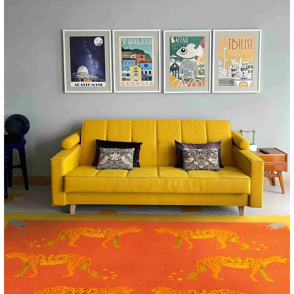 Vivid and artistic area rug depicting wandering leopards in a desert theme, crafted from hand-tufted wool. The rug is showcased in a stylish office setting with a striking yellow sofa and modern wall art, ideal for adding a touch of elegance to office decor.
