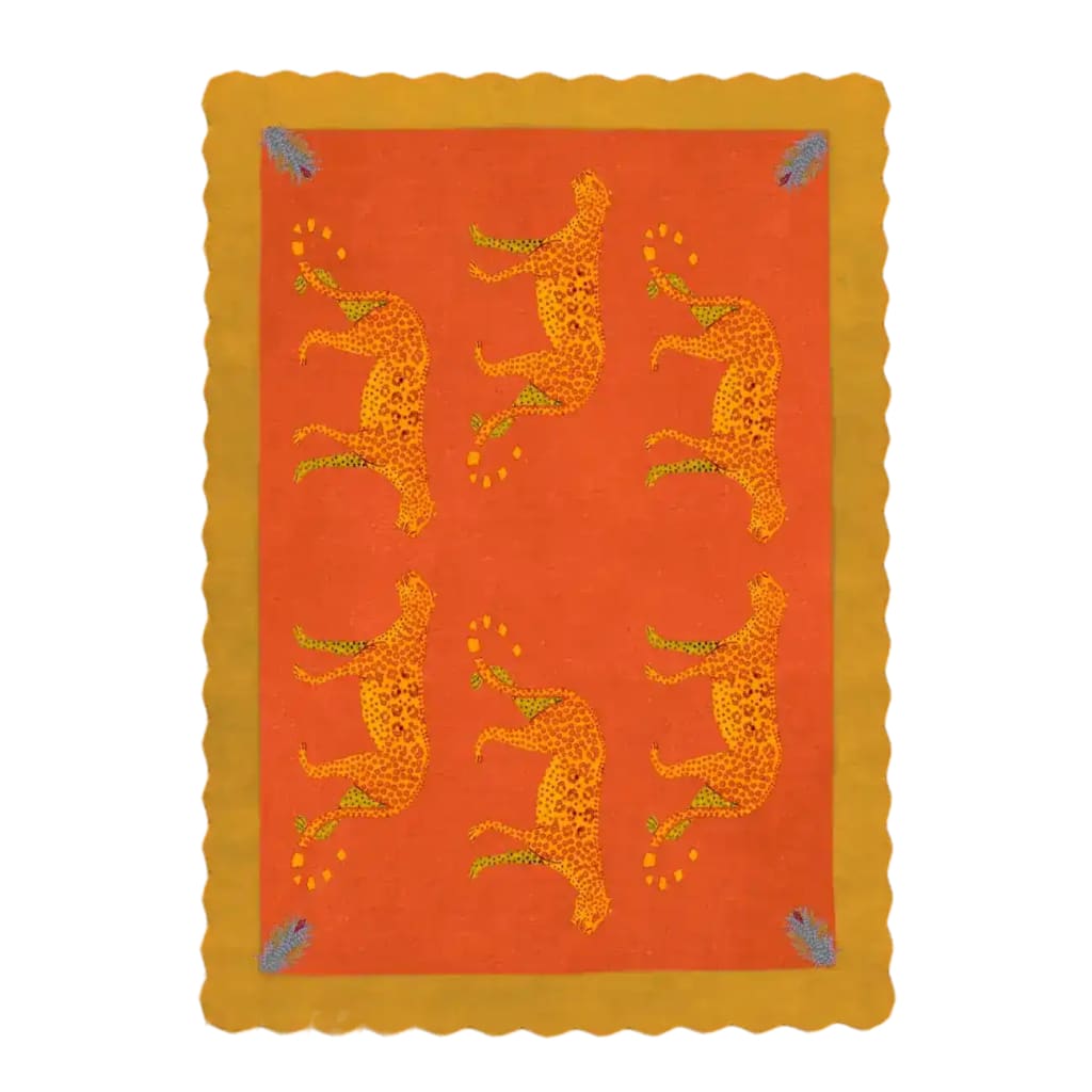 Vibrant area rug with a bold orange and yellow design, featuring artistic leopards. This wool rug offers a unique touch to office decor, showcasing a scalloped edge and intricate patterns.