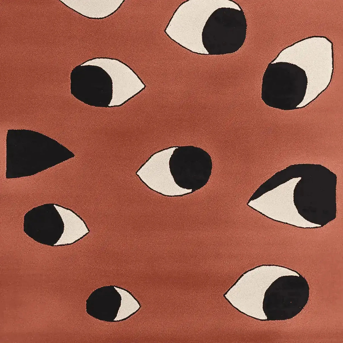 A contemporary area rug with a bold, abstract design featuring eye patterns on a warm terracotta background. This hand-tufted wool rug is perfect for adding a modern touch to living room area rugs.