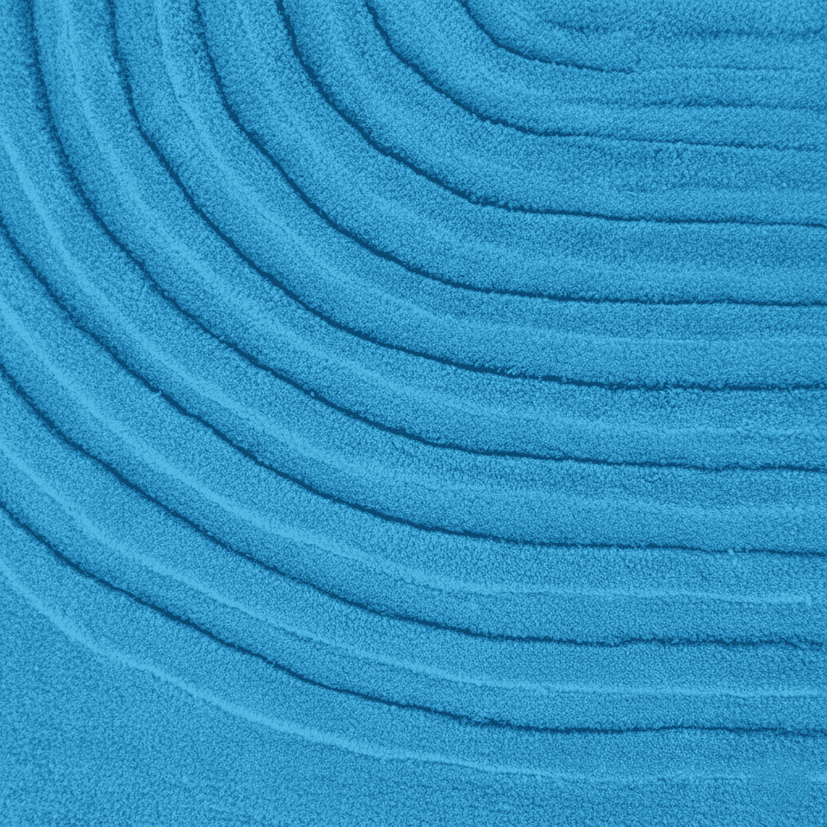 Close-up of blue textured fabric with concentric circular patterns rug