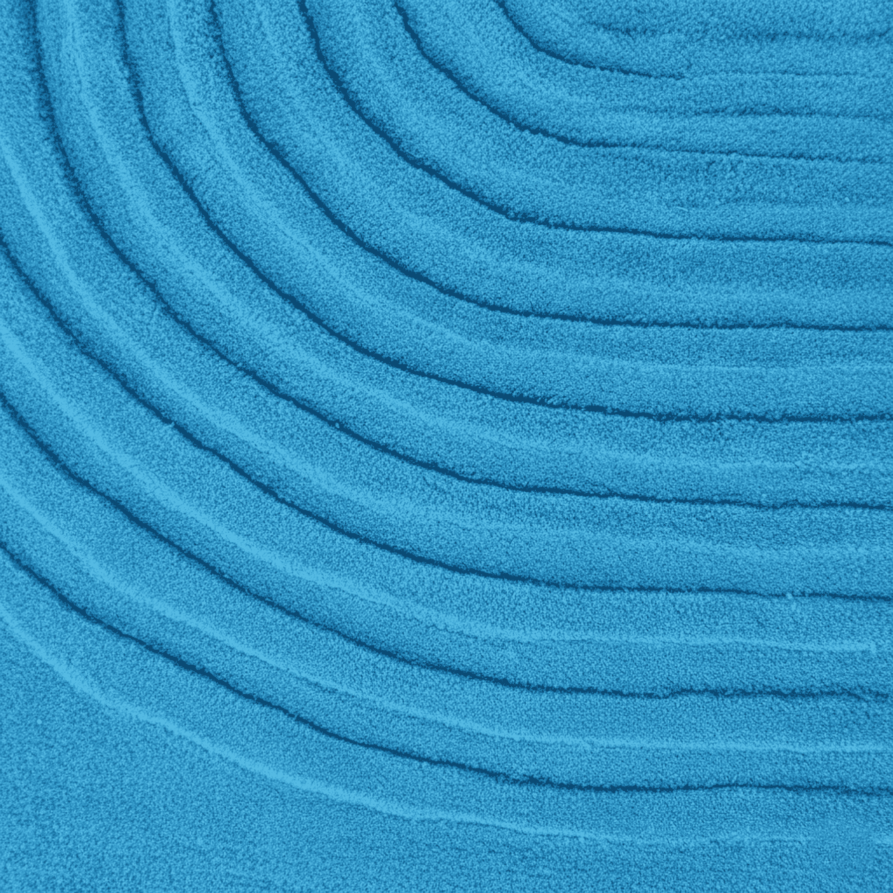 Close-up of blue textured fabric with concentric circular patterns rug