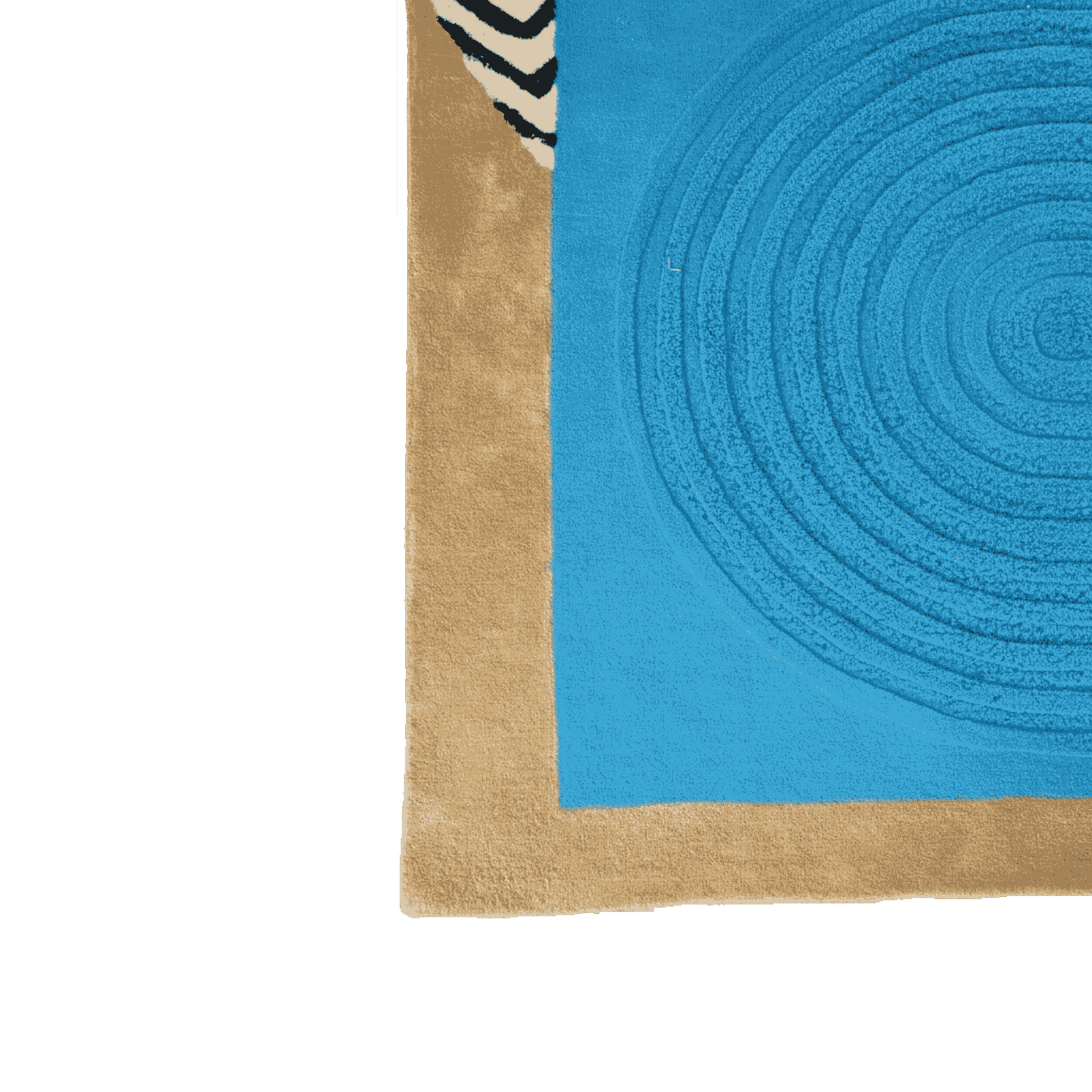 Corner of a blue and beige rug with circular pattern