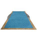 Blue oval rug with brown border and zebra pattern on a transparent background