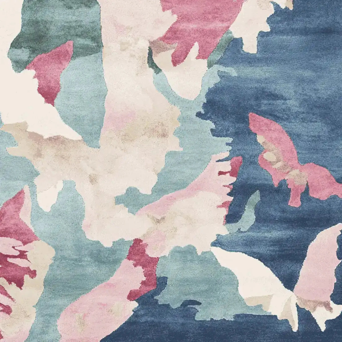 A beautiful watercolor terrain sketch hand tufted area rug featuring an abstract design with shades of blue, pink, and cream. This contemporary wool rug is perfect for adding an artistic touch to living room spaces. Ideal for those seeking unique square area rugs that enhance modern decor.